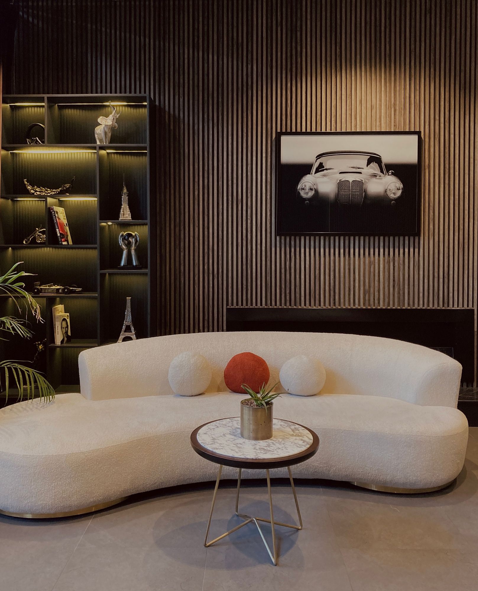 Cream bouclé curved sofa in a lounge, upholstered in Mittals fabric