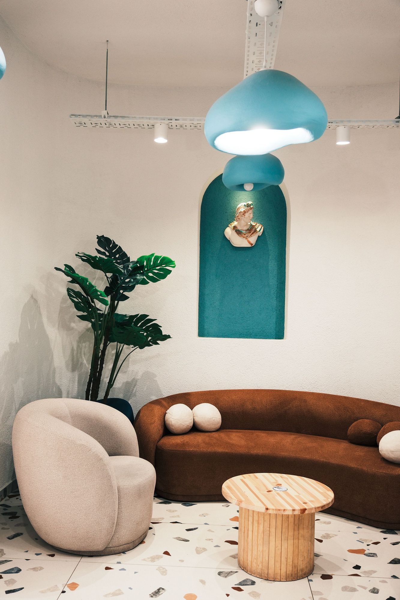 Rust velvet sofa with a bouclé armchair