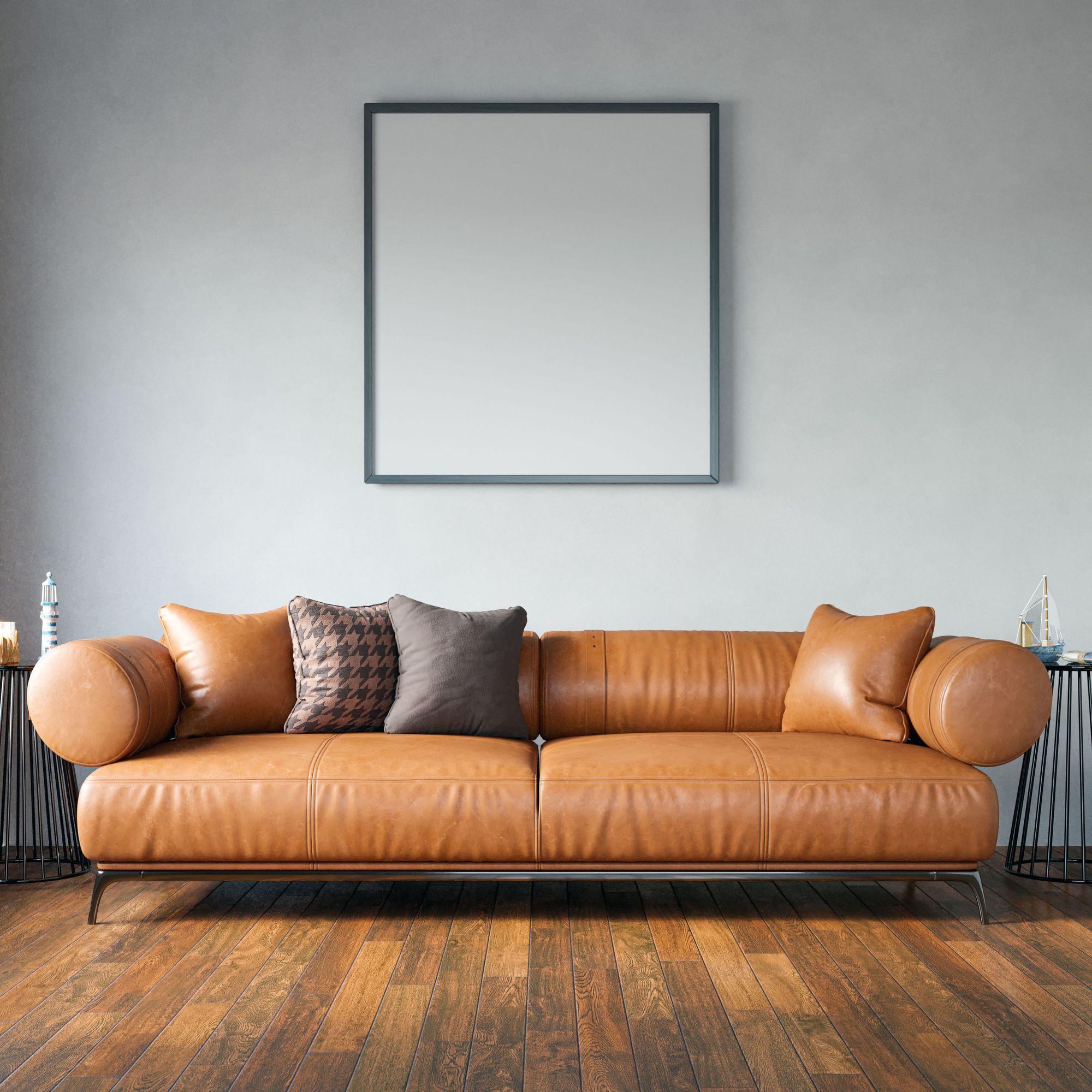 Tan leatherette sofa with houndstooth cushion