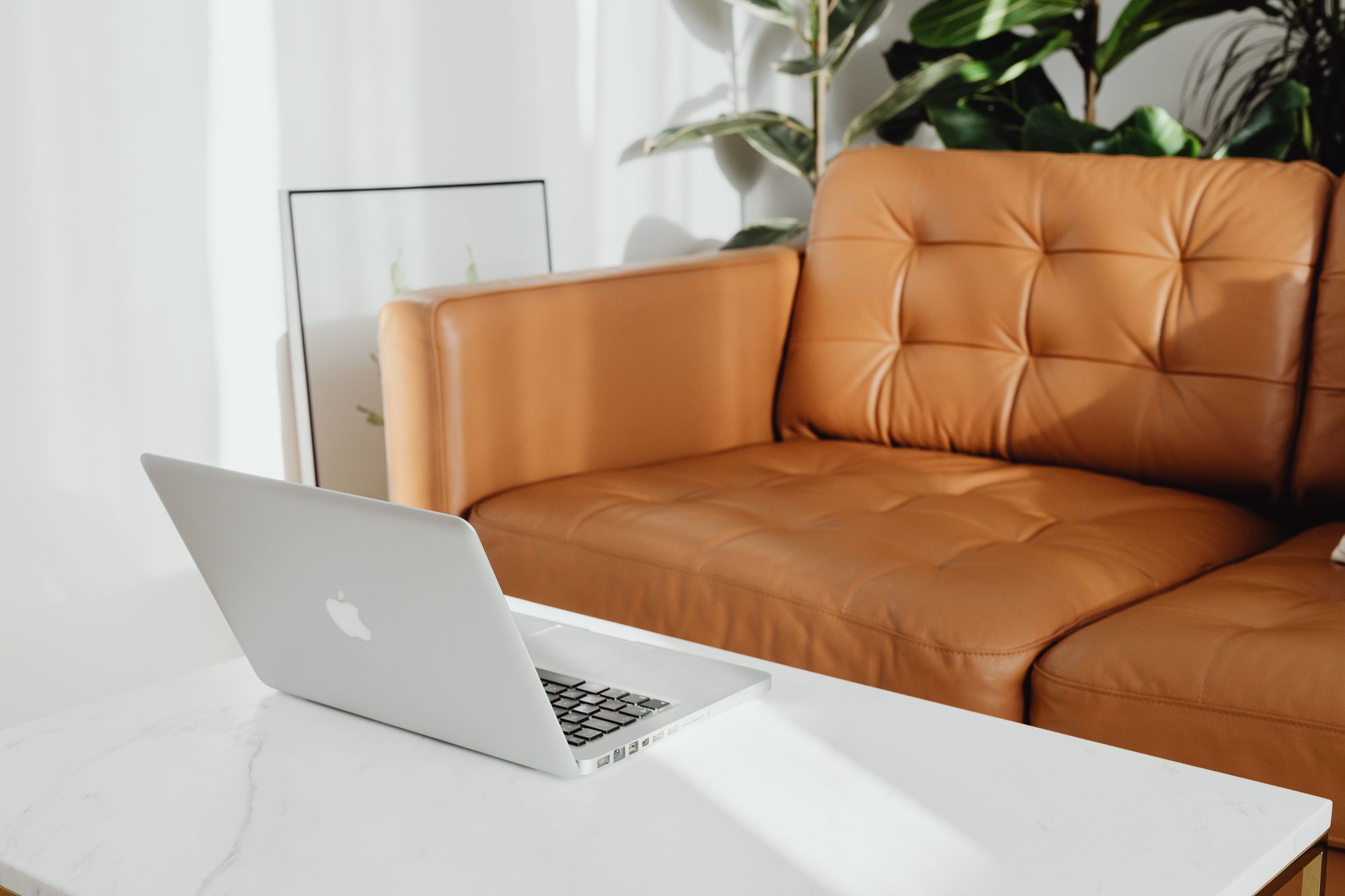 Tan tufted leatherette sofa